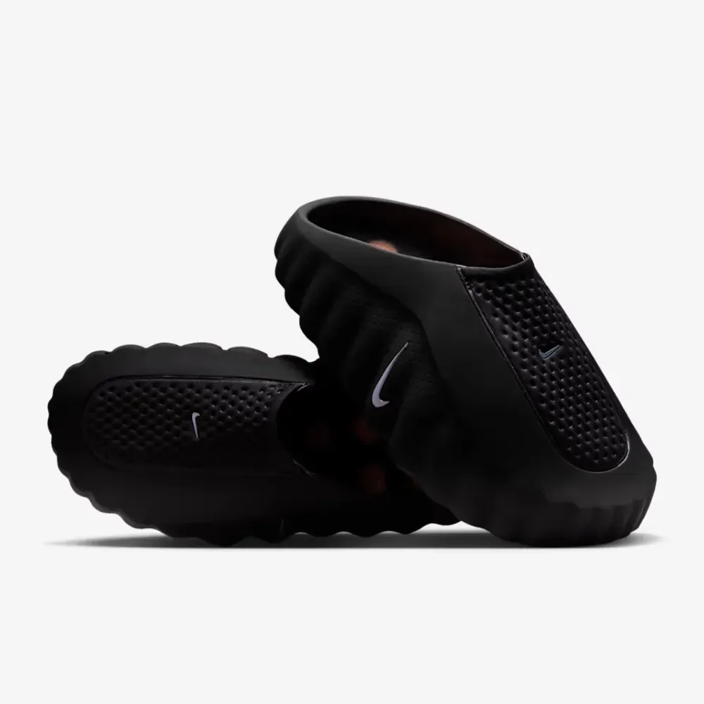 Pair of black Nike Mind 001 recovery shoes stacked on top of each other